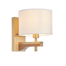 Wall-mounted light fixture with a white shade and gold metal arm on a white background